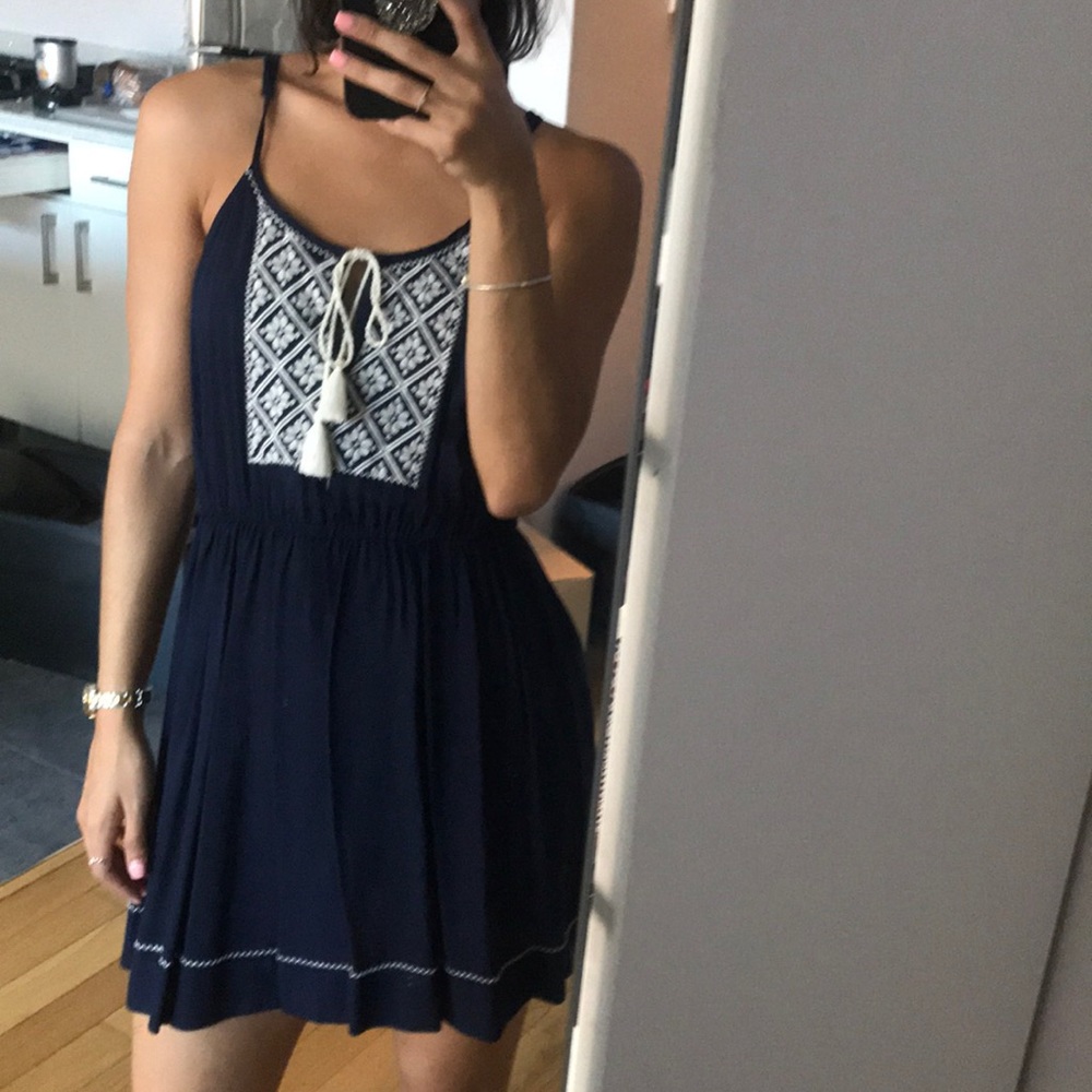 Navy blue dress with white embroidery.